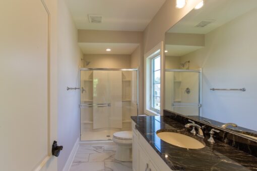 Rivendell bathroom with glass shower and granite vanity