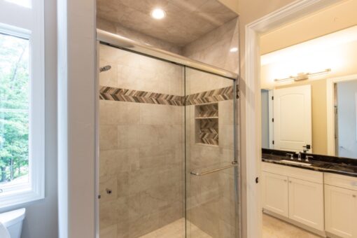 Shire glass shower with mosaic accent band
