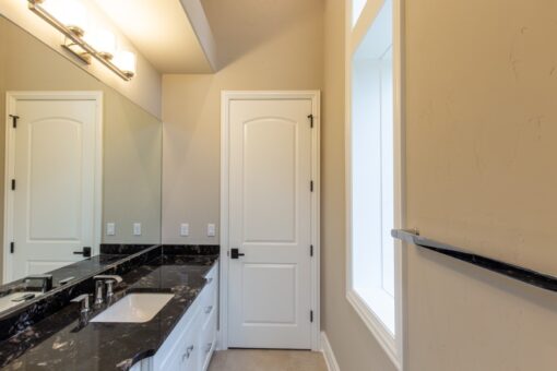 Shire bathroom with dark granite vanity