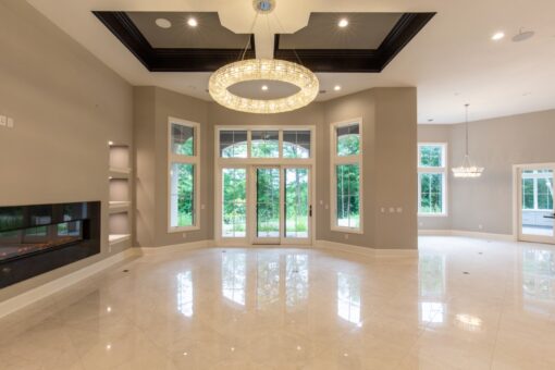Shire lower-level room with ring chandelier and French doors
