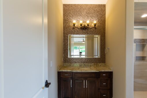 Rivendell bathroom with mosaic tile wall and dark vanity