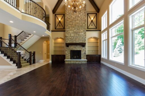 Rivendell two-story great room with stone fireplace and balcony