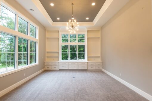 Shire lower-level room with built-in shelving
