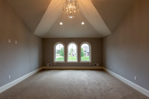 Grand Haven bedroom with arched windows and vaulted ceiling