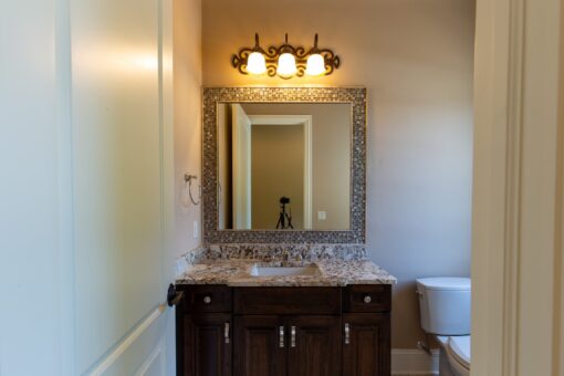 Rivendell bathroom with mosaic-framed mirror and dark vanity
