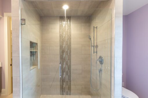Grand Haven walk-in shower with mosaic accent stripe