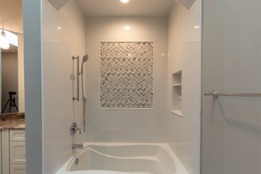 Grand Haven tub and shower with mosaic tile accent