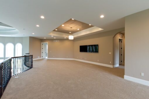 Grand Haven loft with tray ceiling overlooking the stairs