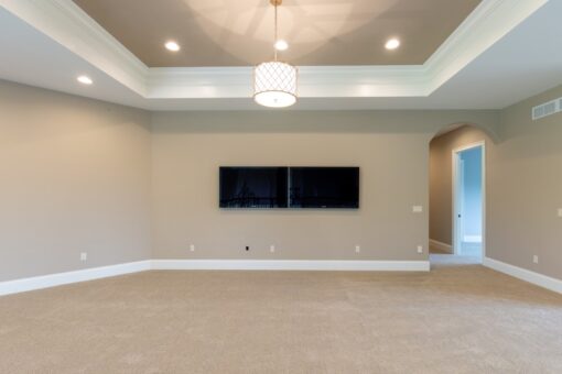 Grand Haven loft with tray ceiling and media wall