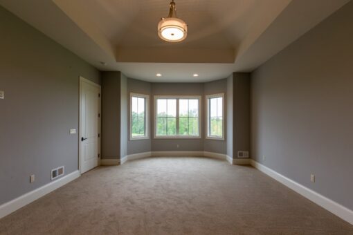 Grand Haven bedroom with bay window and tray ceiling