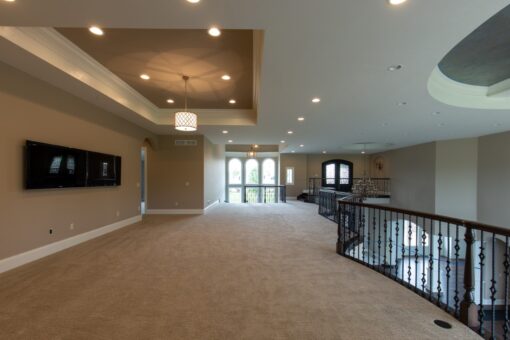 Grand Haven loft with iron railing and tray ceiling