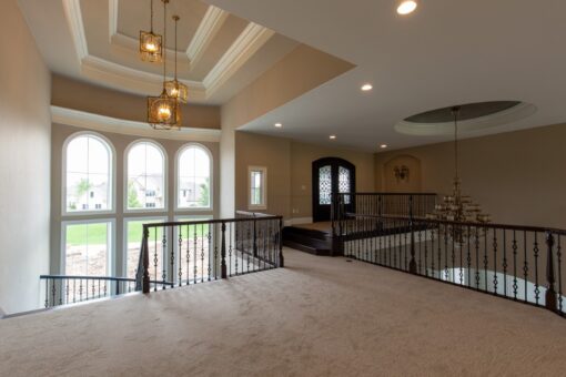 Grand Haven loft with iron railing and arched windows