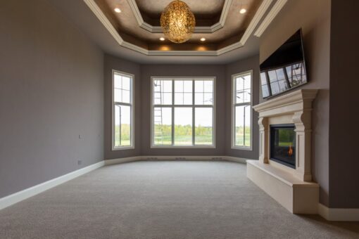 Grand Haven primary bedroom with bay windows and fireplace