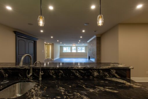 Rivendell lower-level bar with granite counter and pendants