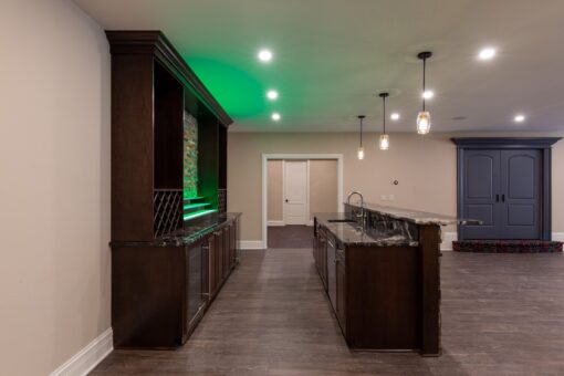 Rivendell lower-level bar with dark cabinetry