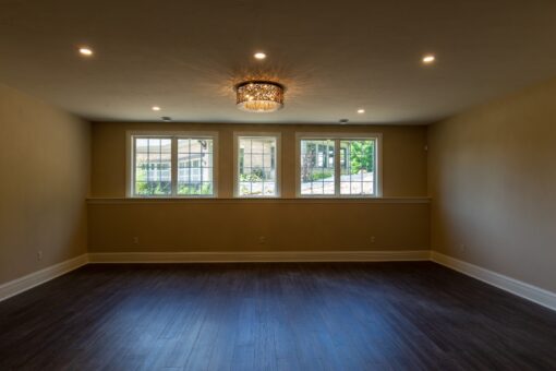Rivendell lower-level room with chandelier and windows