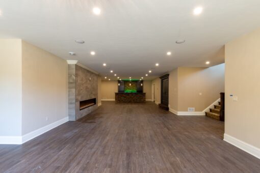 Rivendell lower-level family room with stone fireplace