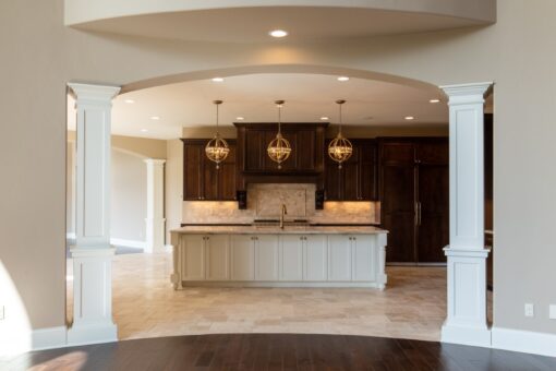Grand Haven kitchen viewed through arched columns