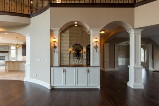 Grand Haven built-in wet bar niche with arched opening and sconces