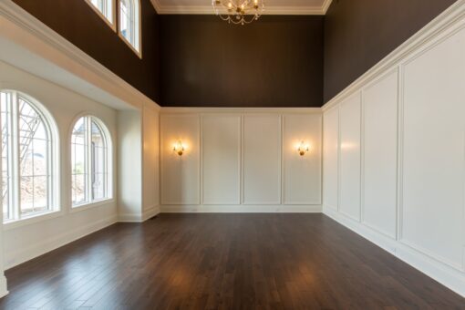 Grand Haven room with paneled walls and arched window