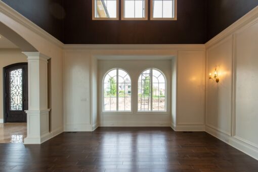 Grand Haven sitting room with wainscoting and arched French doors