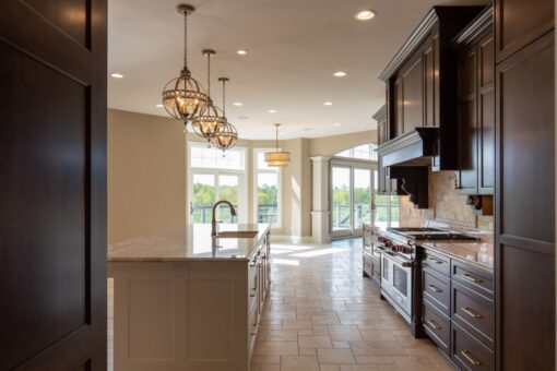Grand Haven kitchen with dark cabinetry, island and range