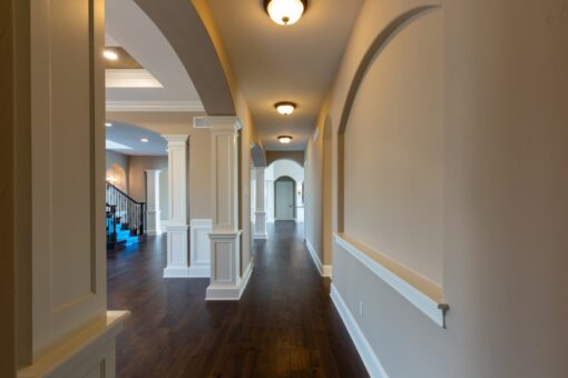 Grand Haven hallway with columns and hardwood floors