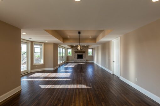 Grand Haven lower-level family room with stone fireplace