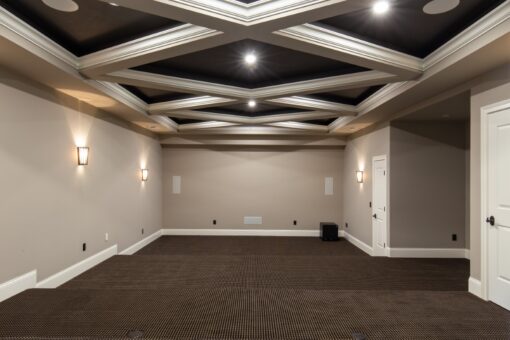 Grand Haven lower-level media room with coffered ceiling
