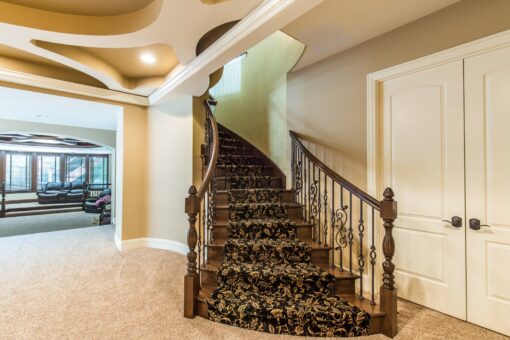 Brandywine curved staircase with carpet runner to the lower level