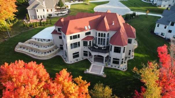 Shire aerial view with red roof, stone exterior and autumn trees