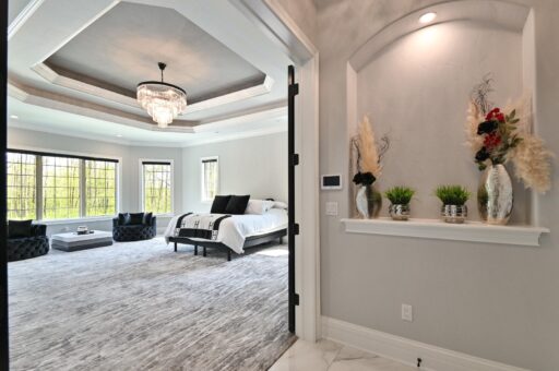 Woodland primary bedroom with tray ceiling and window wall