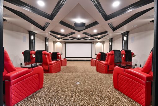 Woodland lower-level home theater with red recliners and coffered ceiling