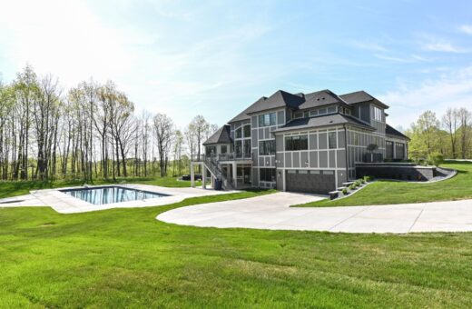 Woodland rear elevation with pool and wooded backdrop
