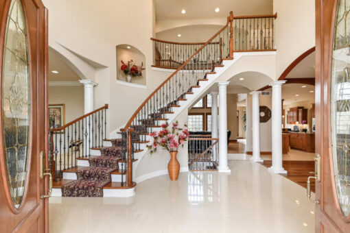 Benington foyer with curved staircase and columns