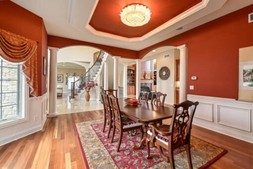 Benington dining room with red walls and tray ceiling