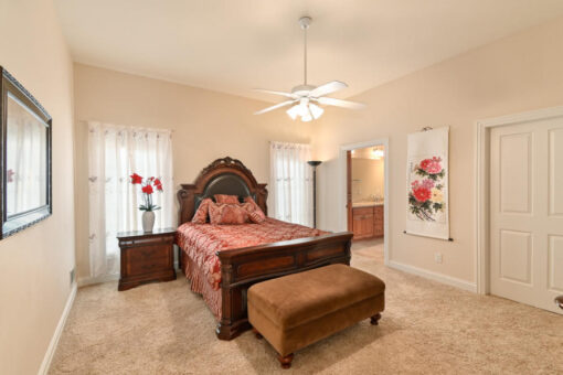 Benington primary bedroom with carved wood bed
