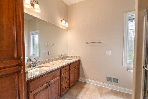 Benington bathroom with cherry vanity and window