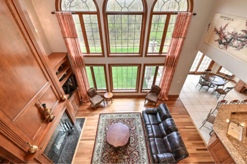 Benington two-story great room with arched windows viewed from above