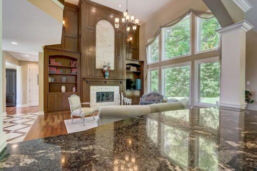 Talon great room with wood built-ins and arched windows