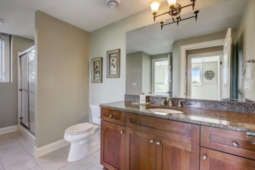 Talon bathroom with wood vanity and granite top