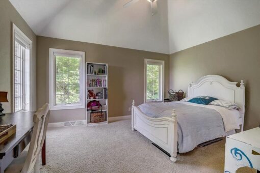 Talon bedroom with vaulted ceiling and windows