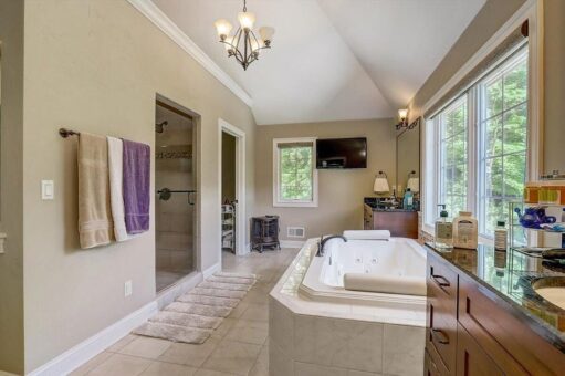 Talon primary bath with soaking tub and chandelier