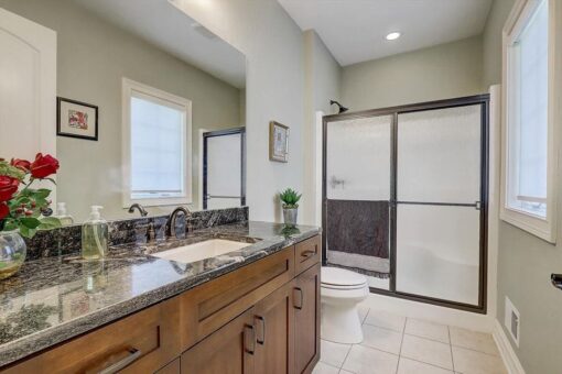 Talon bathroom with granite vanity and glass shower