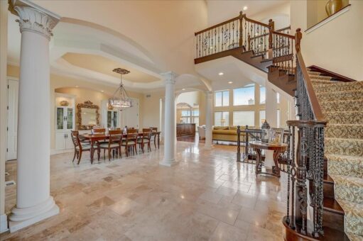 Edington great room with curved staircase and dining area