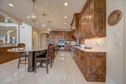 Edington kitchen with wood cabinetry and breakfast bar