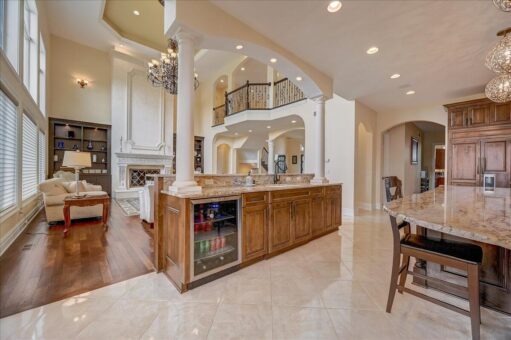 Edington kitchen island with wine refrigerator and balcony view