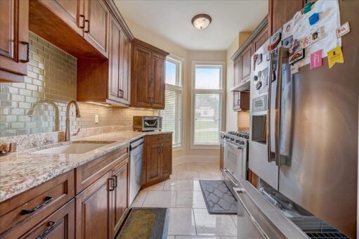 Edington kitchen with wood cabinetry and stainless appliances