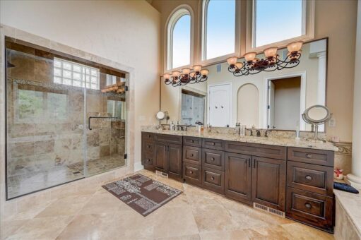 Edington primary bath with arched windows and long vanity