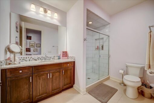 Edington bathroom with wood vanity and glass shower